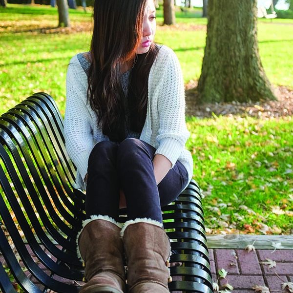 23669307 - lonely young woman sitting on a steel bench